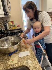 Nana and little Brian bake together